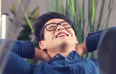 Male student smiling in a workspace
