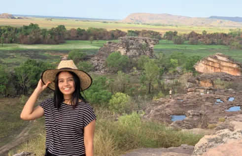CDU student Srijana Ghimire standing against a backdrop of a national park in the Northern Territory