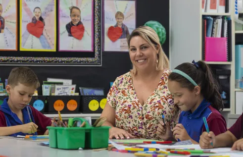 ALISHA working with a child in the classroom 