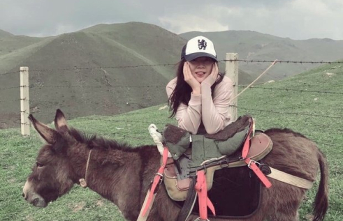 Chengxi Li sitting on a donkey