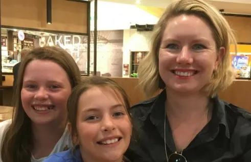 Elizabeth smiling with her two children