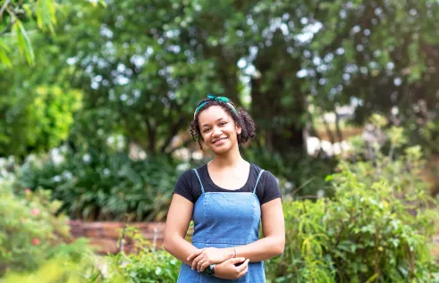 Genevieve smilling in a garden