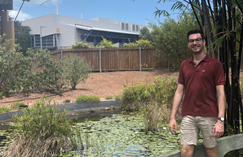 Matthew standing in front of a pond