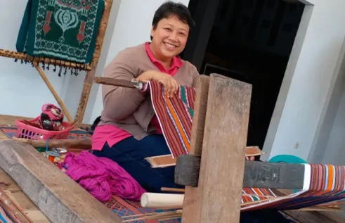 CDU student Dina Widyaputri Kariodimedjo on a loom