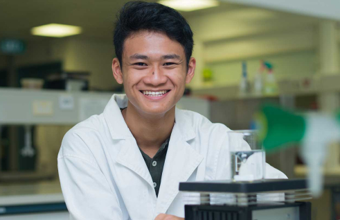 Nam in his lab coat smiling