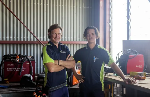 Yron smiling with his apprentice