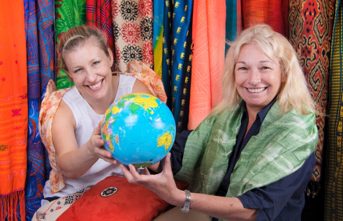 Enterprising women holding the world globe and smiling