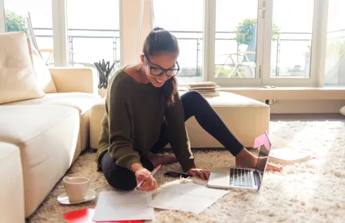 Lady studying on the lounge floor 