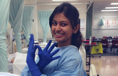 ishita in medical scrubs and gloves