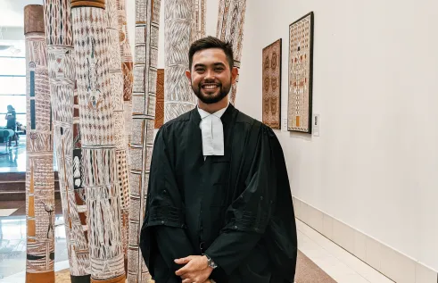 CDU student Max Stretton smiling in his graduation robes