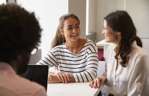 Teenager and their parent having a discussion with a third person