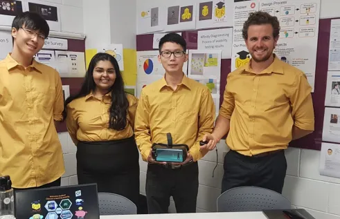 Reema smiling with her colleagues