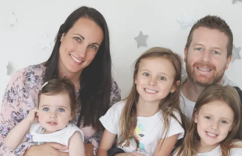 Sallie in a family photo with her partner and three children