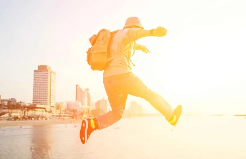 Student with a backpack at sunset