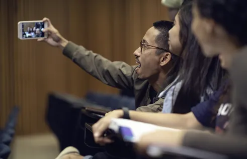 Students in a lecture theatre or classroom taking a selfie
