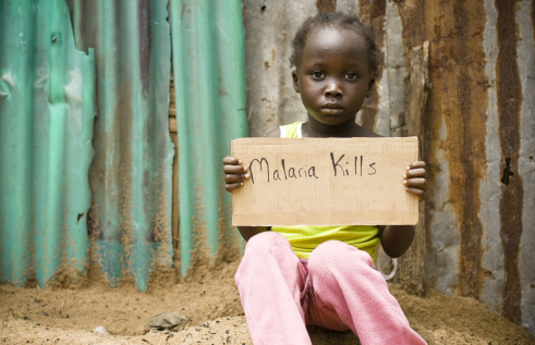 Girl holding up a sign that reads malaria kills