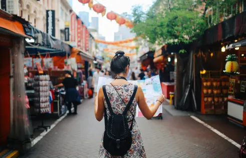 Stock image of study abroad student reading a map in Asia