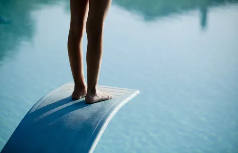 Stock image representing change showing person about to dive into a pool