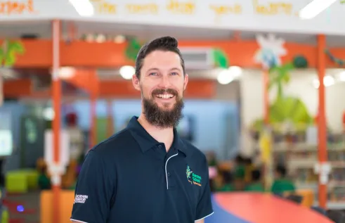 Portrait of a male teacher in a classroom