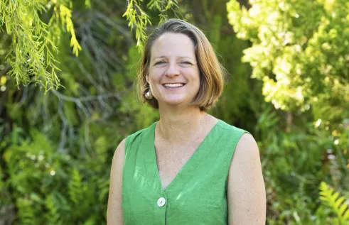 Pia Harkness head and shoulders with plants in the background