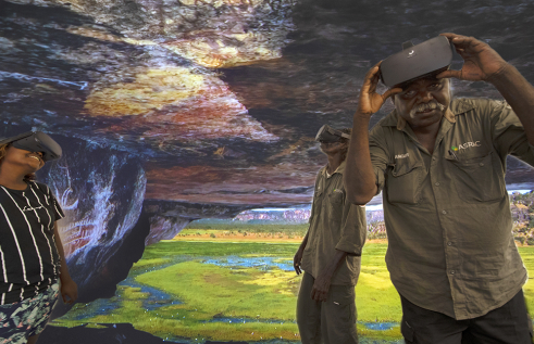Arafura Swamp Rangers Aboriginal Corporation members Erica Ngurruwuthun, David Bidingal and Charlie Ramandjarri test out the virtual reality technology at CDU.  Virtual reality image courtesy of Injalak Arts. 