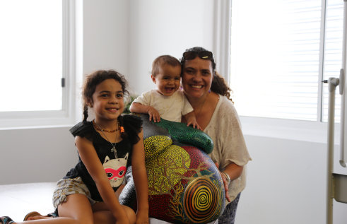 Participant and midwife in the Birthing in Our Community program in Brisbane’s southern suburbs, Kyleigh Brown-Lolohea, with her daughters and belly cast made during her pregnancy
