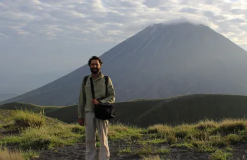 Tom Duncan with hill and clouds in background