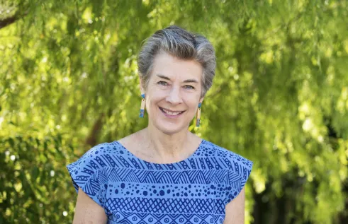 Jane Munday head and shoulders with green leafy background