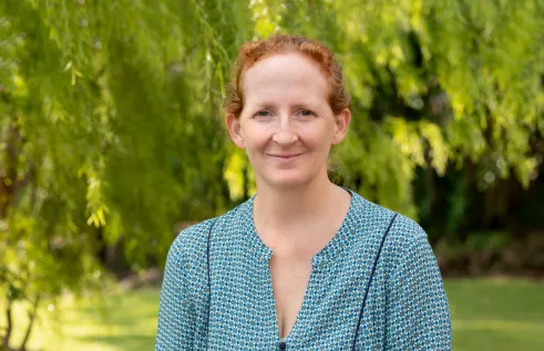Dr Emily Gibson head and shoulders with green leafy background
