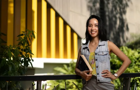 MBA student Ellie holding book on campus