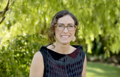 Dr Gianna Bonis-Profumo head and shoulders with green leafy background