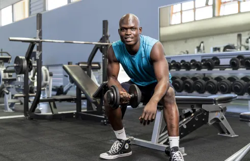 Gym user using a dumbbell