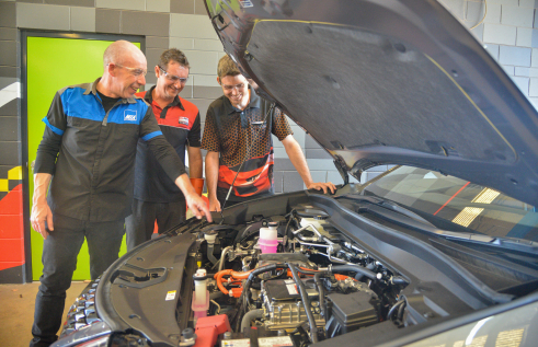 Former CDU student and The Dent Pusher Director David Eves and Prompt Auto Repairs Director Scott Petschel complete training with MTA training assessor Steve Richardson at CDU as part of a new hybrid vehicle training course held at the Casuarina campus.