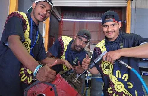 Young First Nations men working on Valiant car