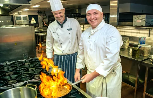  Darwin local and Charles Darwin University (CDU) Certificate III in Commercial Cookery student Stellio Ginis is putting his cooking skills to the test as he prepares to represent Australia at the Culinary Olympics in 2024.  Pictured; Stellio Ginis CDU Senior VET Lecturer in Culinary Arts Jason Wilkes