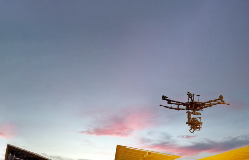 Image of a drone flying in a sunset