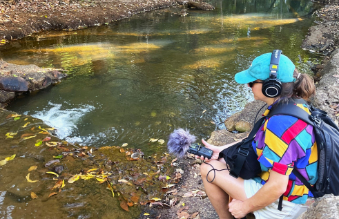Researcher Jen Macdonald takes sound recordings of Rapid Creek waters