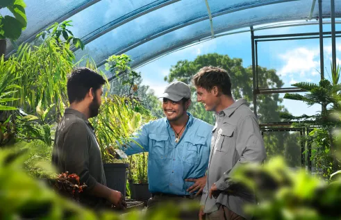 Conservation student AJ in greenhouse