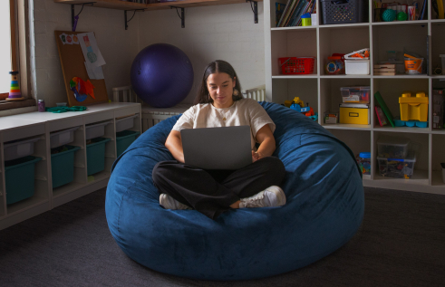 Occupational therapy student Dom studying on a beanbag