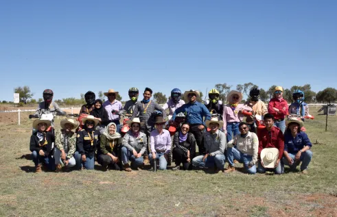 student pose with motorbikes 