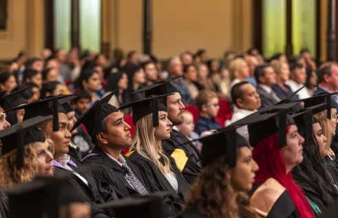 graduates sit at town hall