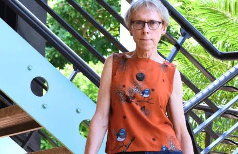 Professor Kim Humphery standing on a Northern Institute staircase
