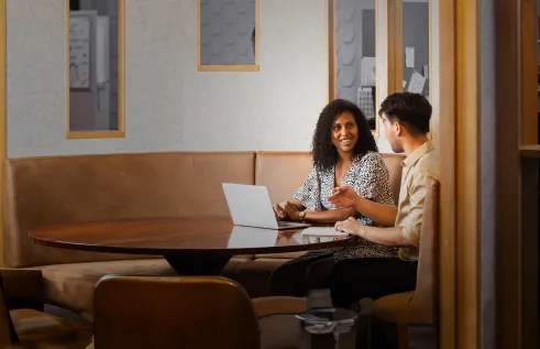 Woman and man in office meeting space