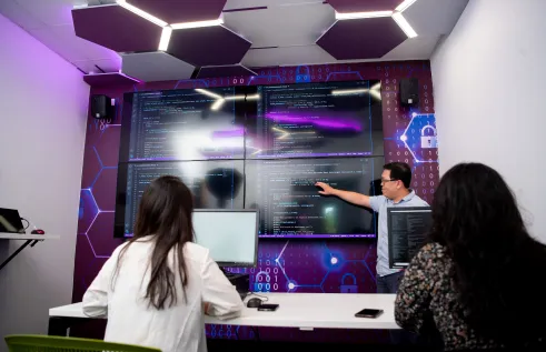 students review coding on large screen