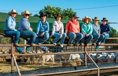 Team photo on cattle fence