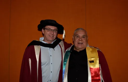 two male researchers pose for camera