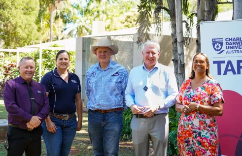 group of people standing in front of CDU TAFE sign