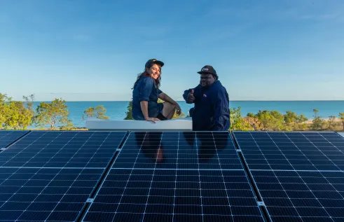 : Scott McDinny and Lauren Mellor installing solar at Mumathumburru (West Island). Credit: Rachel Mounsey.