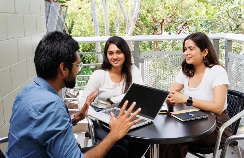 Students at table discussing applications