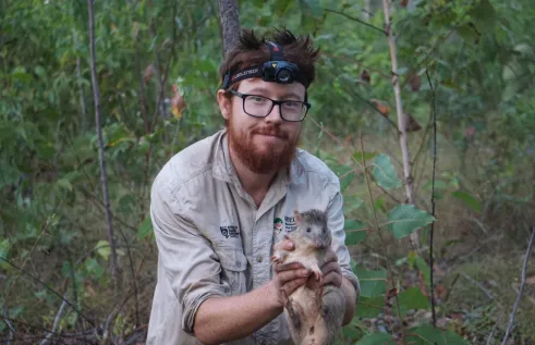 Researcher Alex with native small mammal